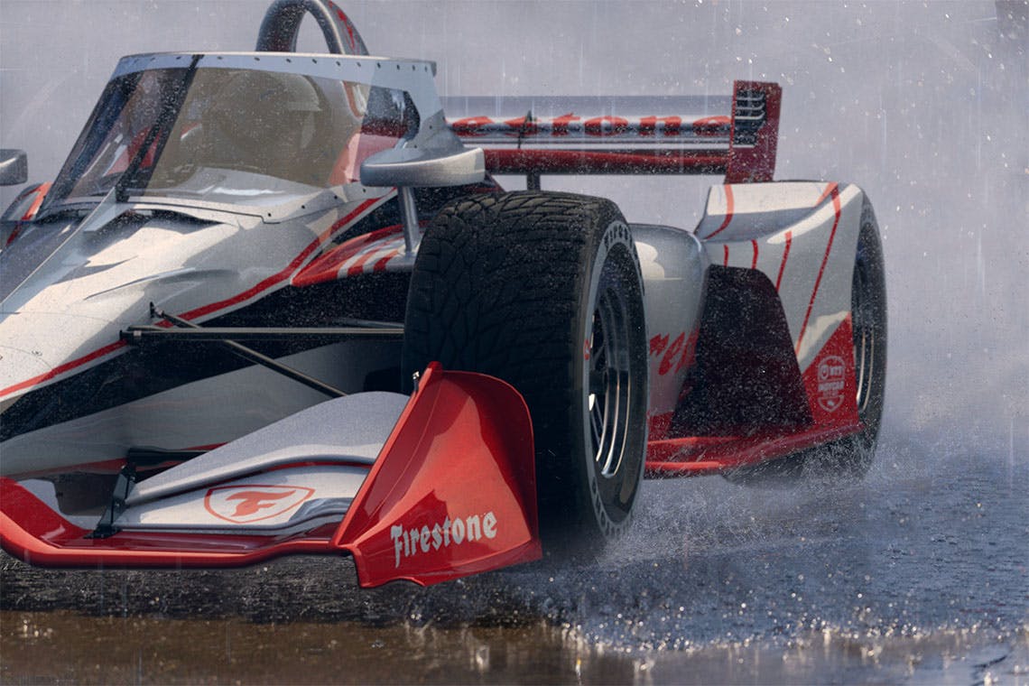 Image of an Indy car driving through the rain.